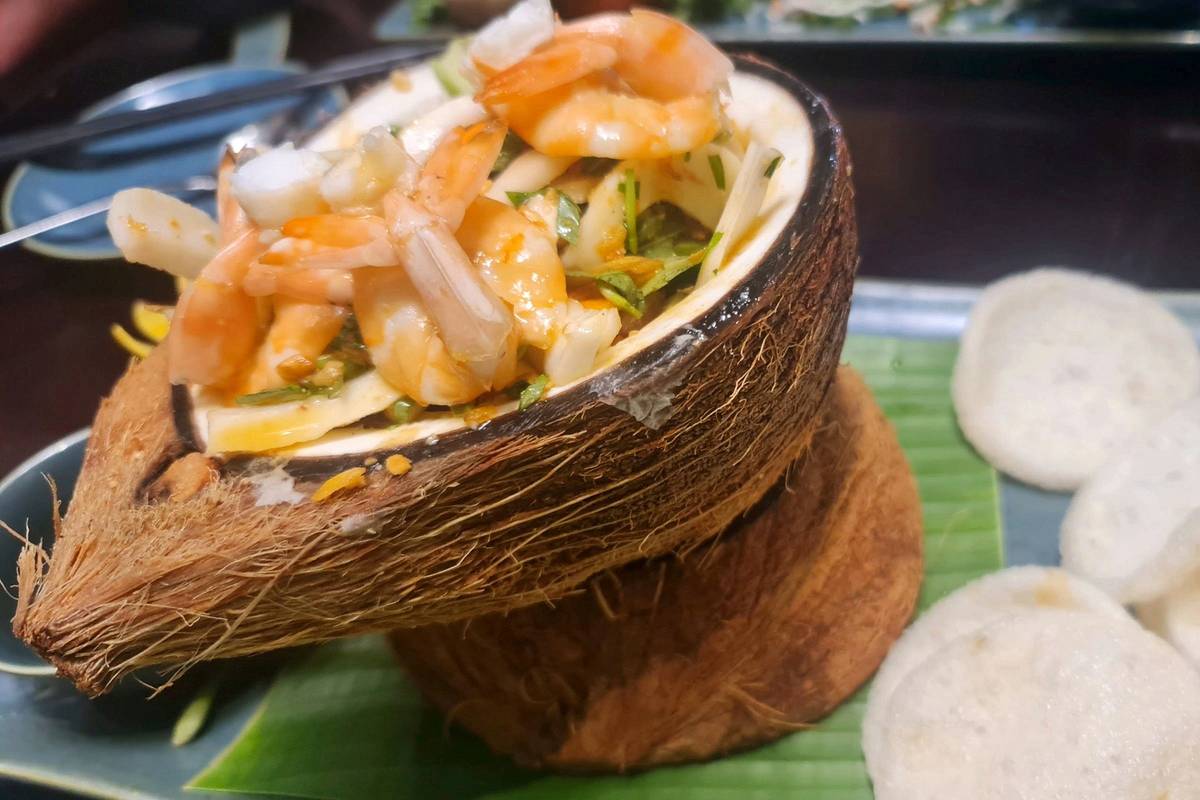 A Vietnamese seafood dish served in a coconut shell at a restaurant in Ho Chi Minh City